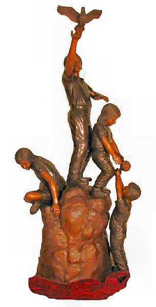 Life Size Bronze Statue of four children on a rock catching a dove